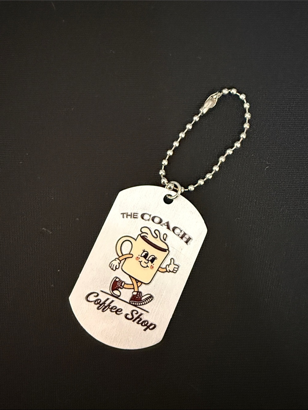 Coach Coffee Shop “Little Miss Jo” Silver-Tone Coffee Dog Tag Keychain